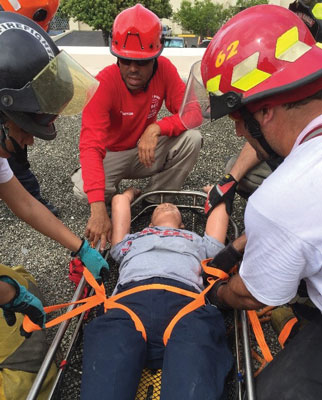 (1) Students are securing the victim into the rescue basket with a one-inch tubular webbing harness. After the harness, the patient can be secured with another webbing that crosses the patient in an “X” pattern three times. <i>(Photos by author unless otherwise noted.)</i> 