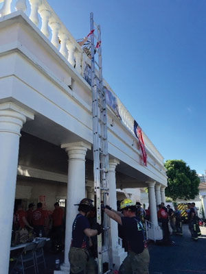 (10) Two or more firefighters place the ladder flush against the building.