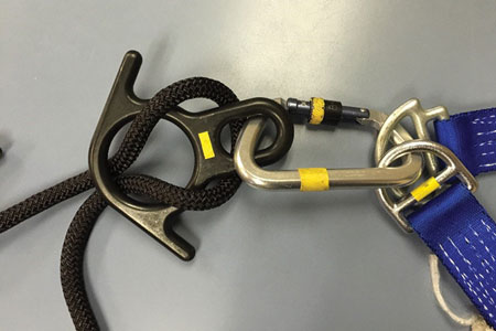 (<b>5-6) </b>A rescue 8 with ears is used as the lowering device, which is attached to the anchor plate with a carabiner. When possible, anchor to a structural member of the building. 