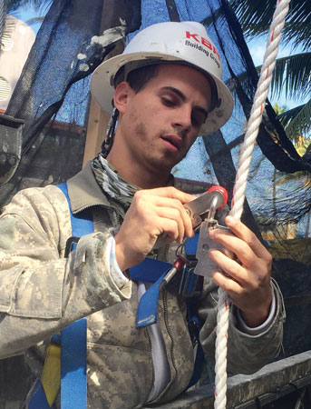 (7) The worker is attaching his shock-absorbing lanyard to the rope grab on the lifeline.