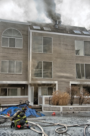 (1) Smoke is seen from the first floor or ground floor, which is above a parking garage. This building might get confusing depending on what you call the floor levels. You can also see smoke showing from the vents at roof level. <i>(Photos by Glenn Duda.)</i> 