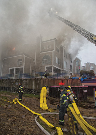 (8) Members can be seen stretching large-diameter hose to the fire area. Water supply will be difficult and must be preplanned.