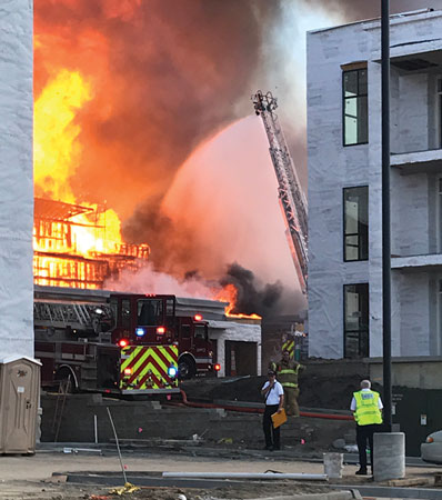 (3) Apparatus were positioned in place to protect exposure buildings in various stages of construction. <i>(Photo by Addie Chapin.) </i>