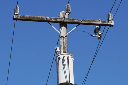 (1) High-voltage overhead primary lines with a 120-volt stepdown transformer. They are typical in a residential area. (Photos by Chris Greene.)