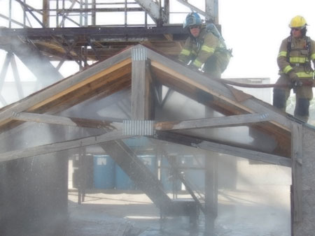 (4) A piercing nozzle spray pattern demonstration using a roof and attic space prop and an end view of the spray pattern.