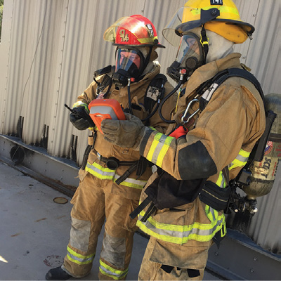 (1) Firefighters approach a suspected chemical suicide vehicle in turnout gear and SCBA while also monitoring the air. (Photos courtesy of Jason Rogers, HazSim  Training.)