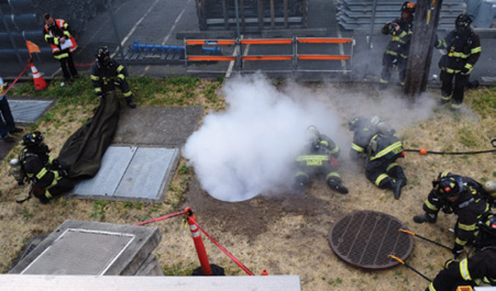 (4) Vault Fire Response Group training with Seattle City Light. High-pressure CO2 is introduced into the energized vault space. This space is energized at 15 kilovolts during the exercise. This maneuver is extremely scripted to ensure consistency and safety. Each position is critical for a safe and an effective offensive posture. 