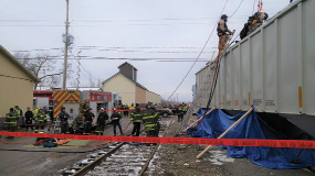 (4) The confined space technicians prepare to make entry into the railcar. Other personnel attend to ropes, communications, and SAR lines. (Photo by Jamie Renner.)