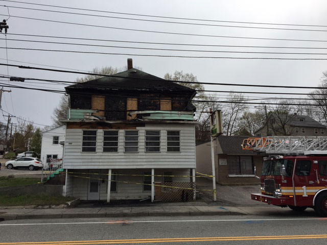 A burned-out building and a fire truck