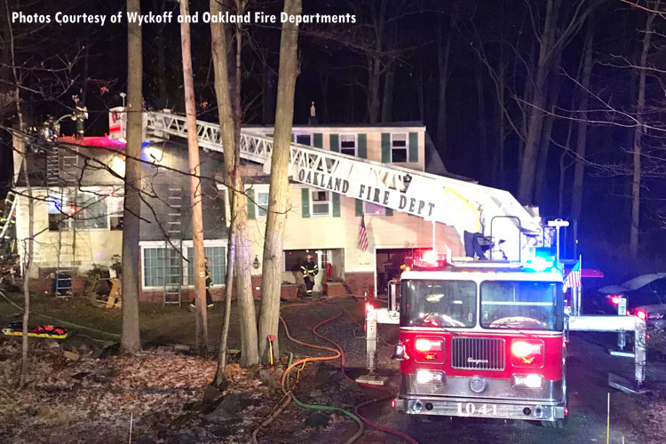 Apparatus positioned at the scene of a house fire in Oakland, New Jersey