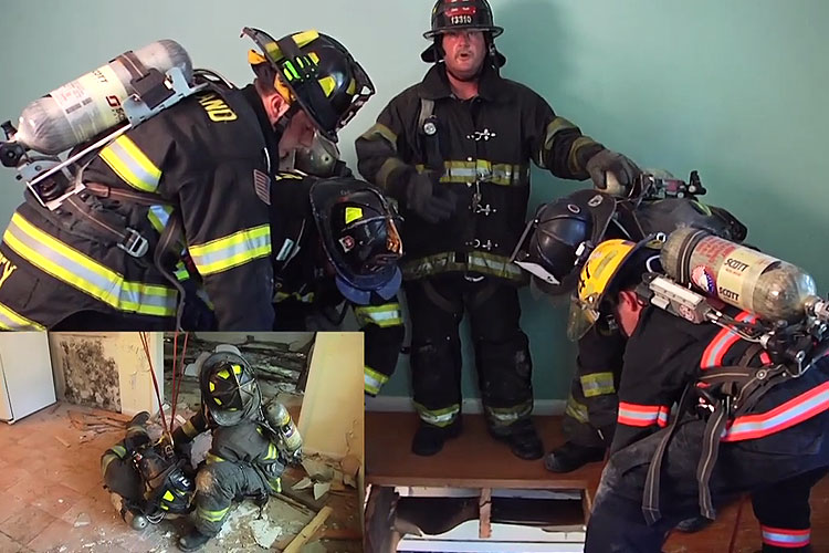 Firefighters rescue a colleague who has fallen through the floor