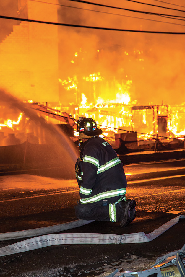 (1) A firefighter cools four of the 12 LPG tanks in proximity to the fire. (Photos by Peter Danzo, PAD Photography, unless otherwise noted.)