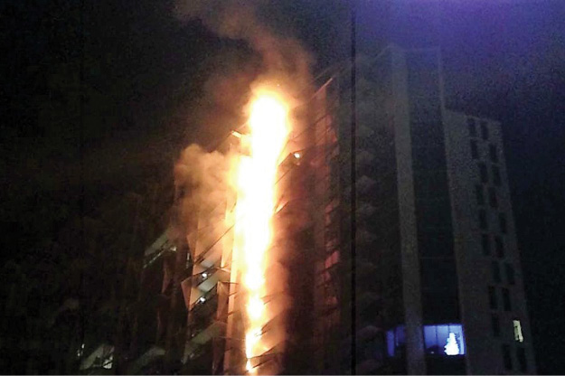 (3) The Forté building during the cladding fire event in 2014. A cigarette discarded on the balcony ignited the garden furniture. Because this cladding is used extensively globally, firefighters should consider whether their department has the resources to handle an event of this dimension. In this context, overreliance on inbuilt fire systems (sprinklers and so on) may be to our detriment because the building and its systems are designed to contain fires occurring within the building. (Photo by Wade Savage; used with permission.)