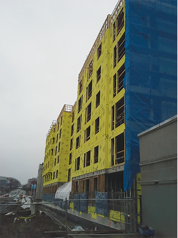 (3) This incomplete building in Seattle, Washington, is typical of the construction method for mid-rise buildings (Type 5): a concrete plinth with concrete or steel frame with infill framing and dividing walls of small dimension lumber. (Photo by author.)