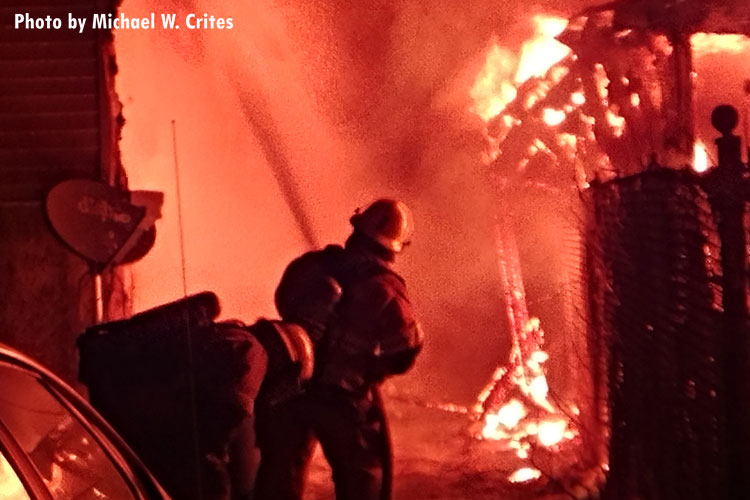 Firefighters protect an exposure building