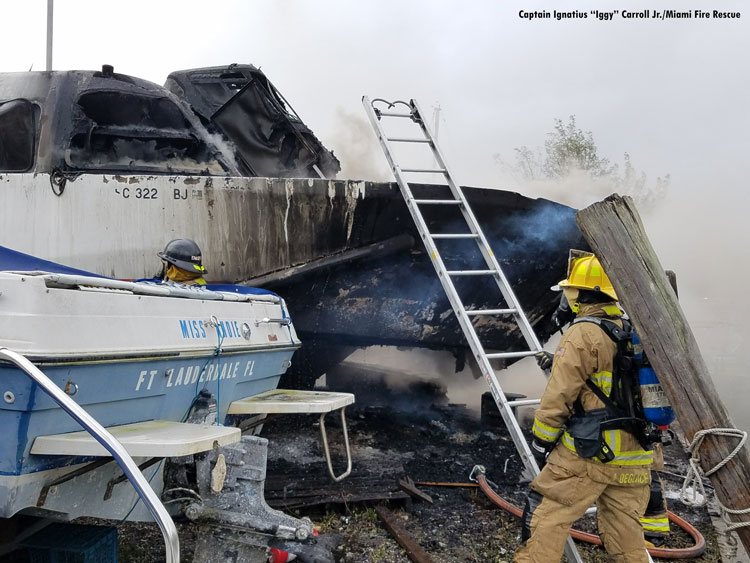 Miami firefighters with burned boat