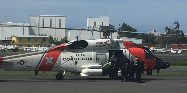 (3) Members of VA-TF2 load a Coast Guard helicopter for St. Thomas.