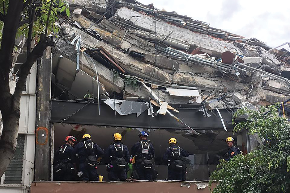 (1) L.A. County firefighters assigned to USA-2 (United States US&R Team 2) beginning search operations at a partial pancake collapse near Mexico City. (Photo courtesy of the L.A. County Fire Department.)