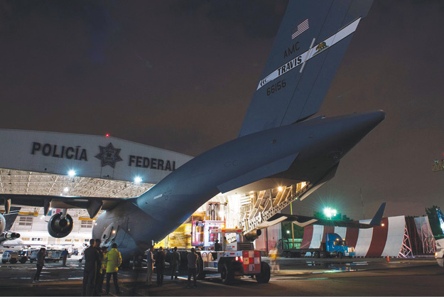 (8) L.A. County firefighters preparing to offload the USA-2 equipment cache after landing in Mexico. (Photo courtesy of the L.A. County Fire Department.)