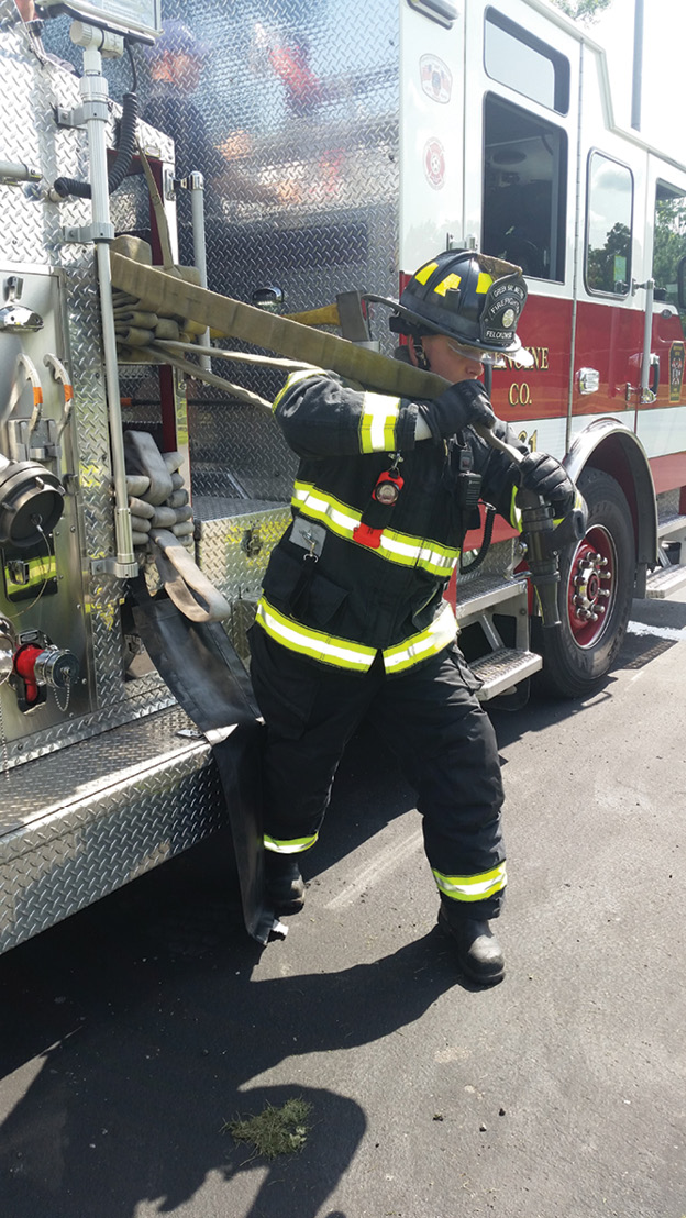 (2) This firefighter is initiating a crosslay preconnected stretch. Used for a common setback of 70 feet, this 200-foot line is a standard pull for residential fires in this district, but it is chosen only after a size-up of fire conditions, apparatus placement, and a hoseline stretch have been completed. The initial line must achieve the triad of reach, flow, and mobility. 