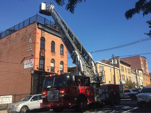 (1) Notice the side rails of this ladder tower. The aerial device is designed for safe climbing. The waterway is built into the underside of the aerial. (Photos by author unless otherwise noted.)