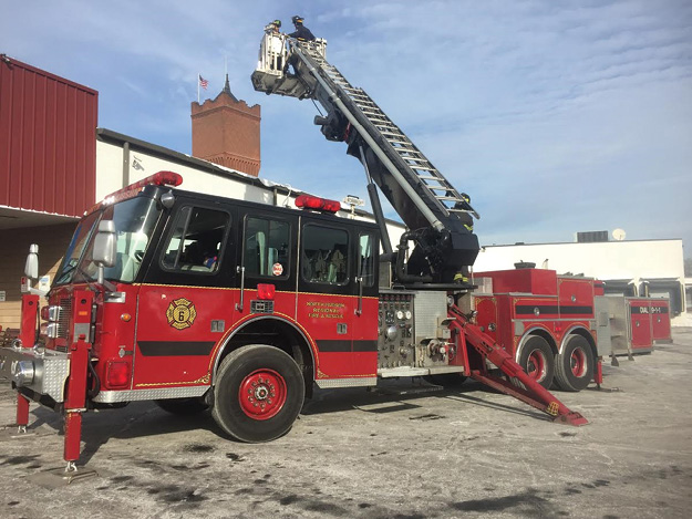 (2) Notice the ladder on this tower ladder. The ladder is there only for emergency escape. The waterway is visible along the left side of the boom.