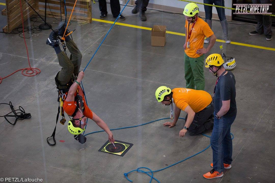 Guy on ropes hanging upside down