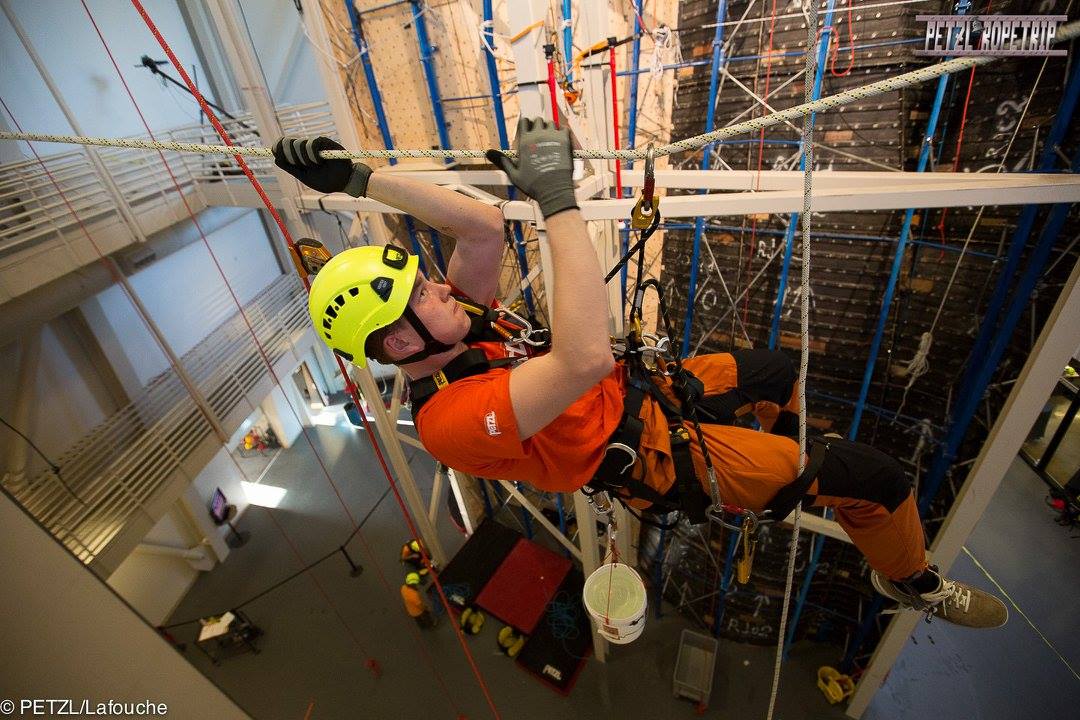 Guy climbing on a rope system