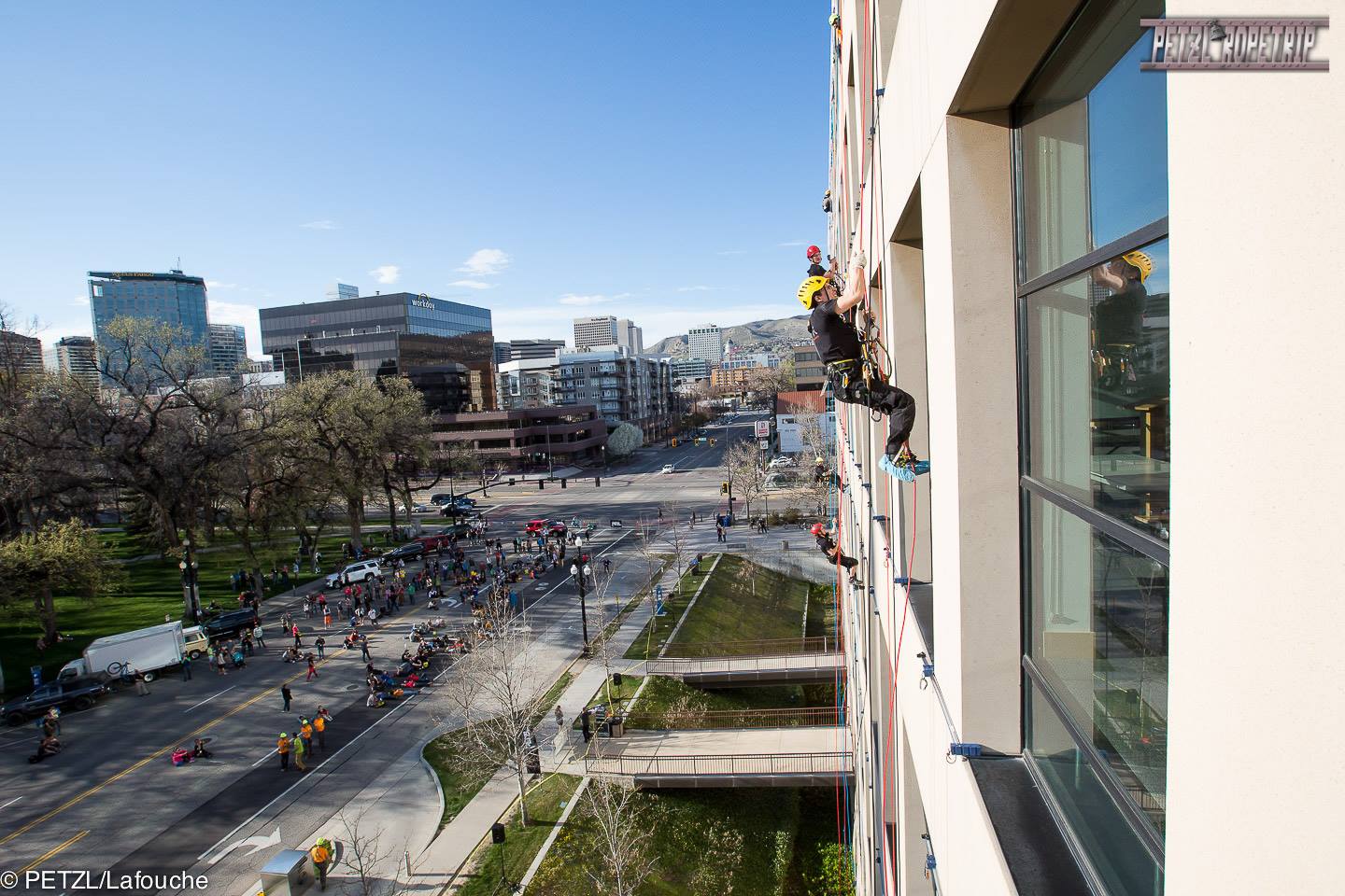 Guy outside a building hanging on a rope