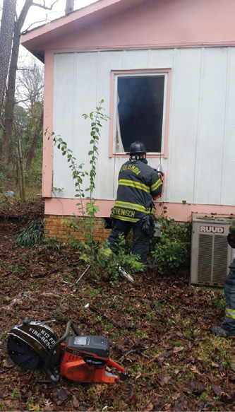 (1) This Columbia (SC) Fire Department member is using a rotary saw to complete a window-to-door conversion. (Photos by author.)﻿ 