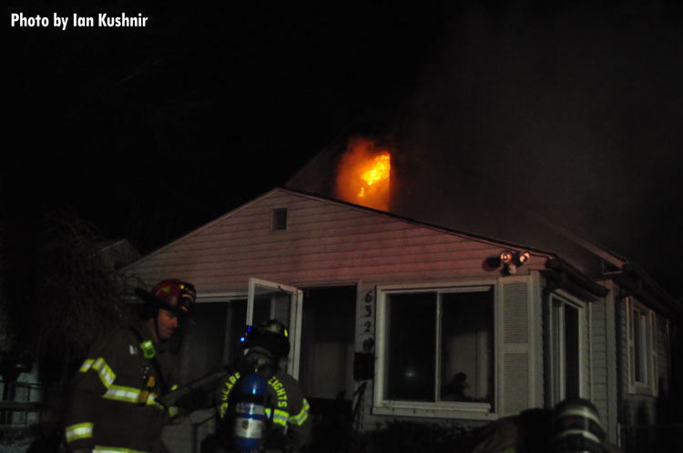 Firefighters outside a burning home