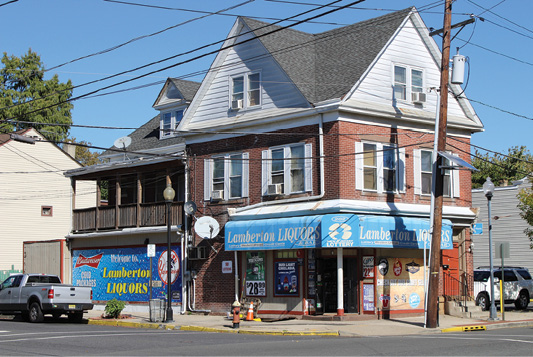 (11) A top-floor fire in this taxpayer consisting of a bar and liquor store with apartments above will require a thorough scan of key size-up indicators for the engine and truck company. Which door will lead us to the fire? From the A-B corner, note the hydrant, window air-conditioning units, the satellite dishes, the store awnings, the power lines, the housing for roll-down security doors, and an apartment entrance with a mailbox on the A-D corner. On the B side, note another apartment entrance with security bars on the windows. In renovated buildings, take the extra time to recon the proper access door that will lead you to the fire BEFORE committing your line. 