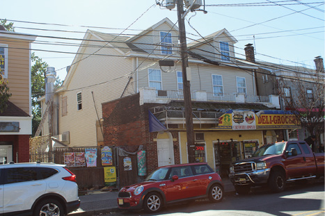 (8) What are some size-up indicators at this taxpayer? It’s ordinary construction with siding over brick on the B side. The access door to one of the apartments appears to be the white door on the A-B corner, but there’s also a rear entrance. A 360° size-up will be difficult as there’s a fence with a dumpster and obstructions present. Throwing ground ladders will also be a challenge because of the awning in front of the store, the blocked fence access to the B side, and numerous wires. There’s an exhaust duct from the bodega kitchen below running up the B-C corner. If the fire originated in the kitchen and ran up the exhaust to the attic, you may be advancing up the interior stairs above the fire without knowing it. Are the dormers real or decorative? It makes a difference in ventilation operations. In this case, it’s critical to get a report from the rear and call for additional resources to cut fencing, locks, and bars; force the door; locate the fire; and conduct primary searches in the living space and exposures. 