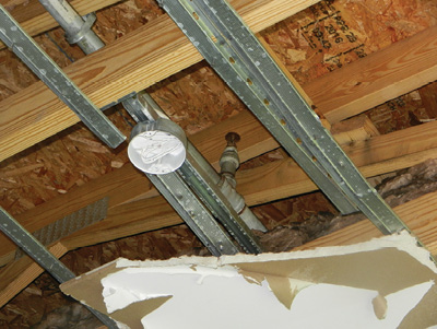 (10) The steel-piped sprinkler system in the attic of the unburned west section of the building. (Photo by Mat Chibbaro.)