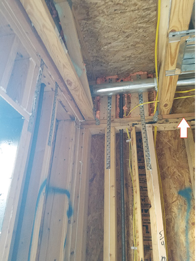 (3) Draftstopping has been installed in this wood floor truss as it intersects the dwelling unit wall, identified by the arrow in the upper right corner of the photo. (Photo courtesy of Eric Moran.)