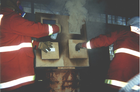 (1) The fire is in the bottom left compartment. The air is restricted, and the flaming combustion ceases; but, pyrolysis continues, and the smoke turns white. (Photos by author except as otherwise noted.)