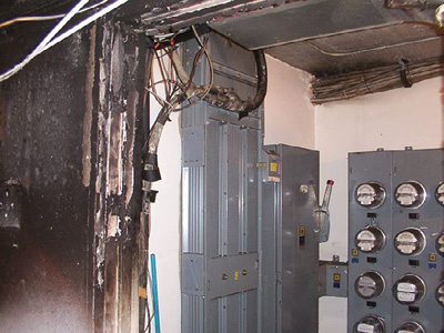 (1) A bus duct, a sheet metal enclosure for copper bus bars, is commonly used instead of cables in conduit for electrical distribution systems of high-rise buildings. This bus duct supplies power from main electrical panels on the ground floor to an electric meter room on an upper floor. [Photo courtesy of the Miami-Dade (FL) Fire/Rescue Department. Remaining photos by Eric Goodman unless otherwise noted.] 