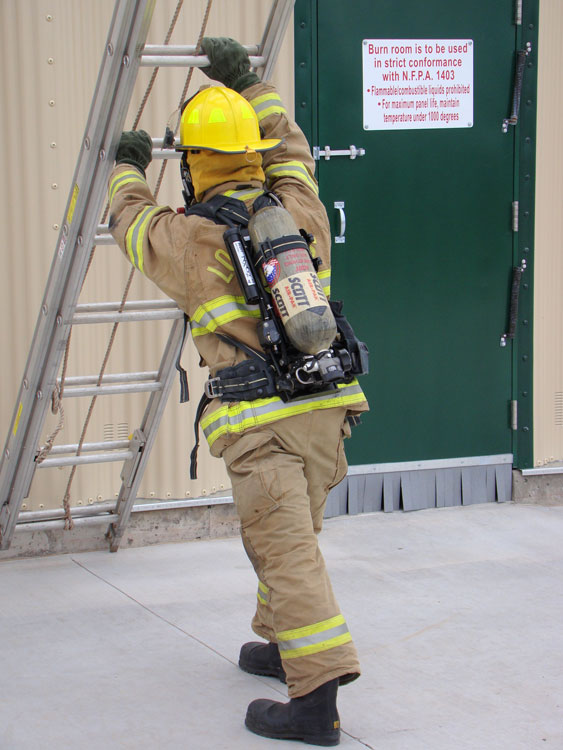 Firefighter raising a ladder