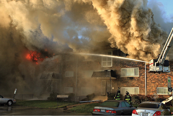 (8) The smoke is pushing from a remote apartment on the A/D corner of the building. More help and more master streams were needed to control the fire.