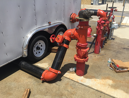 (16) Sprinklermatic pipe fitters connect the pump’s intake to Miami Dade’s training facility’s water main and plumb the pump’s discharge piping directly to the training tower’s standpipe system. (Photos by Mike Posner.)