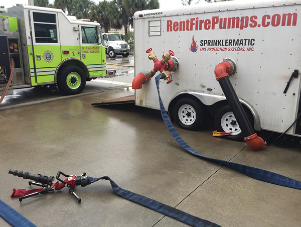 (17) This portable master stream device is connected to the pump trailer’s test connection. The intake and discharge gauges for the pump trailer and the engine pumping the FDC could be readily observed because they were close. (Photo by Mike Posner.) 