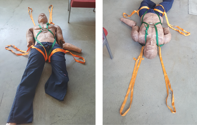 (2) The finished package with two additional grab loops added on the upper thighs using webbing loops and girth hitches. Four firefighters will be able to move a very large victim even if the victim has no clothing.