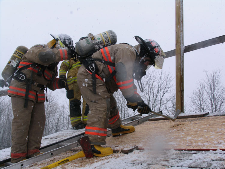 Firefighter uses halligan to cut vent hole