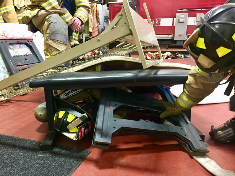 Down firefighter covered in debris