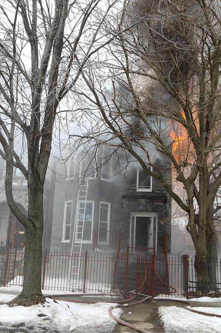 (3) Lines from Engines 45 and 50 going in the front door. Truck 15 has thrown a 20-foot ground ladder to the second floor. Trees obstruct access. The proximity of the B exposure is shown.