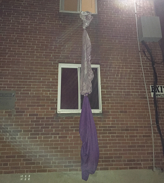 (3) Residents tied bedsheets together to create an escape route out the back of the building during an apartment fire.