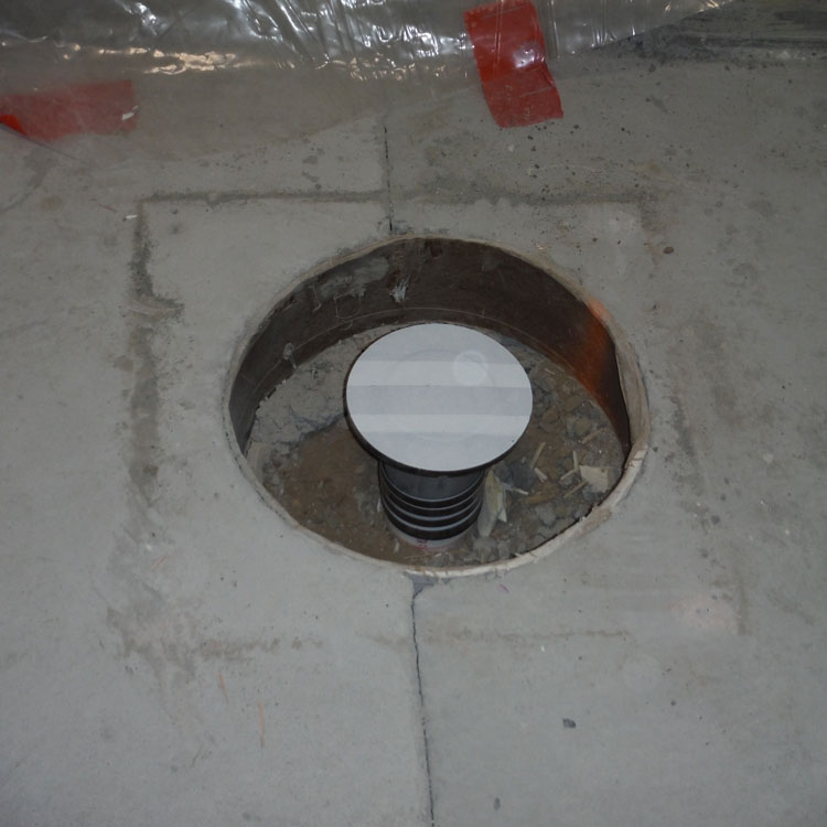 The opening that has been provided around a floor drain in a concrete floor