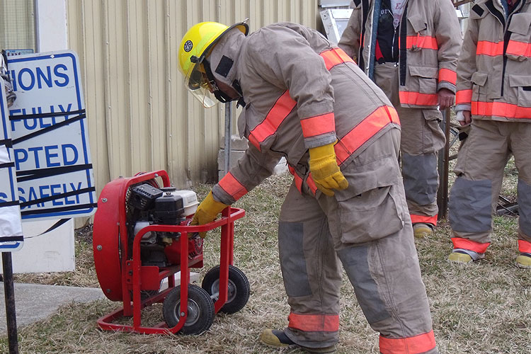 Firefighter operating PPV fan