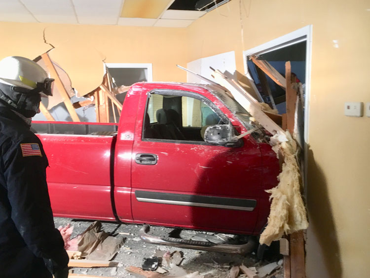 Pickup slams into building