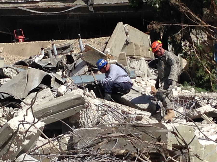 Members of the Indiana National Guard and Indiana Task Force 1 search a collapse area for potential void spaces, applying shared “peel and tunnel” search and extraction techniques. 